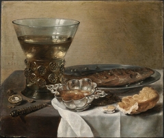 Still Life with Silver Brandy Bowl, Wine Glass, Herring, and Bread by Pieter Claesz