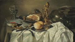 Still Life with ham, books, metalware and kraakware by Pieter Claesz