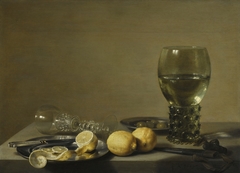 Still Life with Two Lemons, a Facon de Venise Glass, Roemer, Knife and Olives on a Table by Pieter Claesz