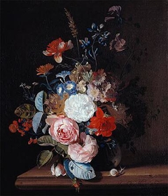 Flower still-life in a glass vase on a stone ledge by Jan van Huysum