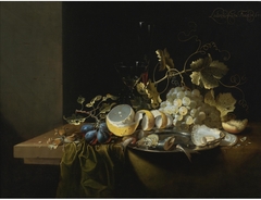 Still Life of Hazelnuts, Grapes, Oysters and Other Foods on a Draped Table by Laurens Craen