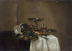 Still life with wine glass, tazza, fish and overturned jug by Cornelis Mahu