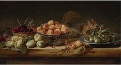 Still life with peaches in a Tazza, hazelnuts on a pewter plate, raspberries in a basket, with pears and a squirrel on a table by Frans Snyders