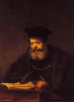 Scholar at his desk by Rembrandt