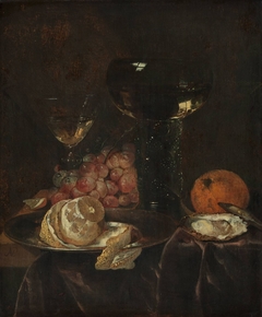 Still life with lemon, grapes and glasses by Abraham van Beijeren