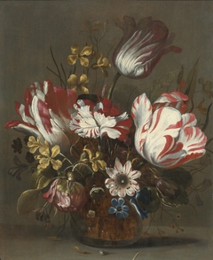 Tulips and other flowers in a glass vase by Hans Bollongier